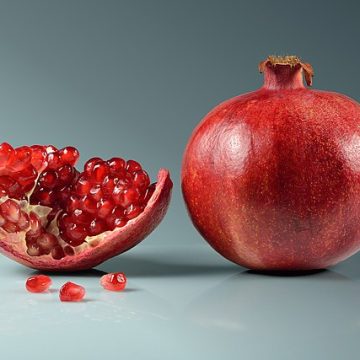whole and cut pomegranate