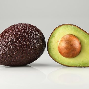 whole and halved Hass avocado